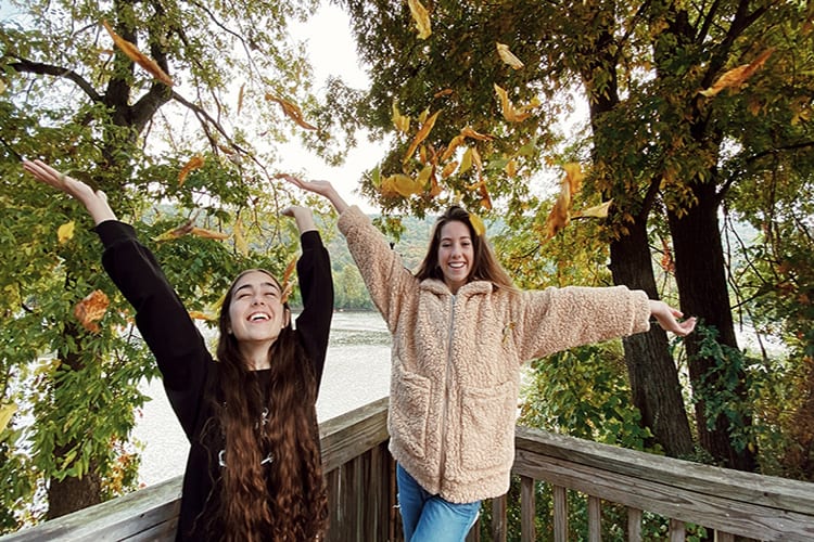 Girls Throwing Leaves in the air